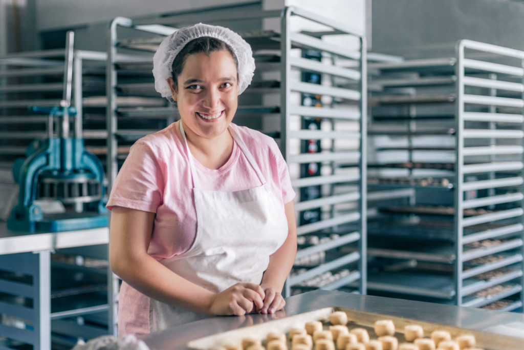 Volunteer with intellectual disability working at a Bakery Workshop.